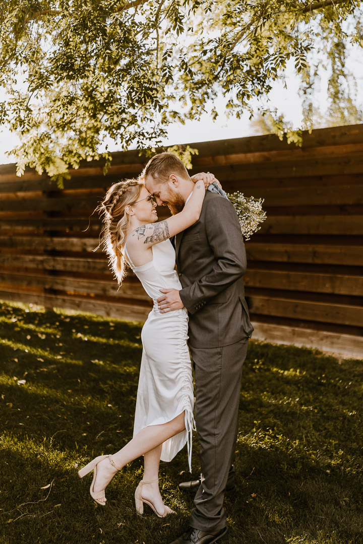 bride and groom embracing during wedding portraits
