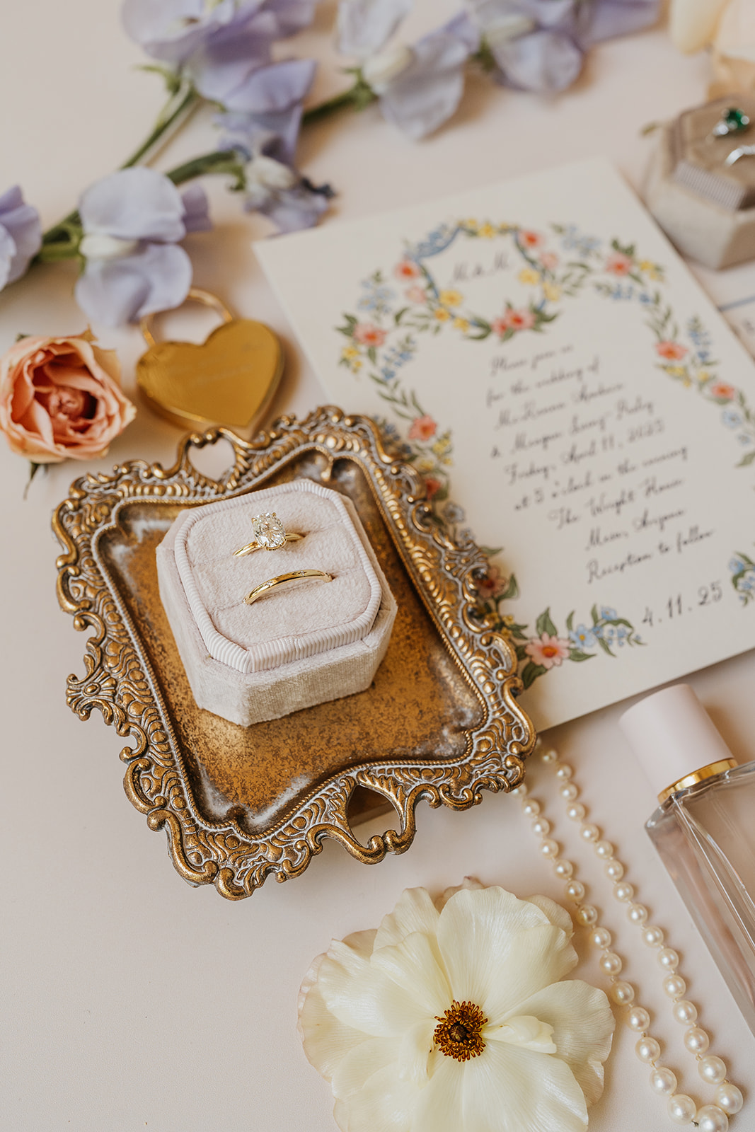 Wedding rings and invitations together in a flat lay